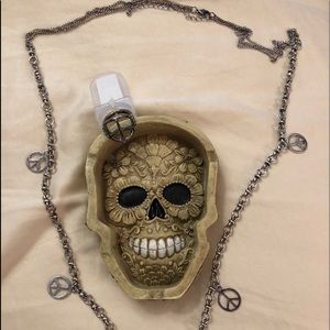 Jewelry holder with peace necklace and ring